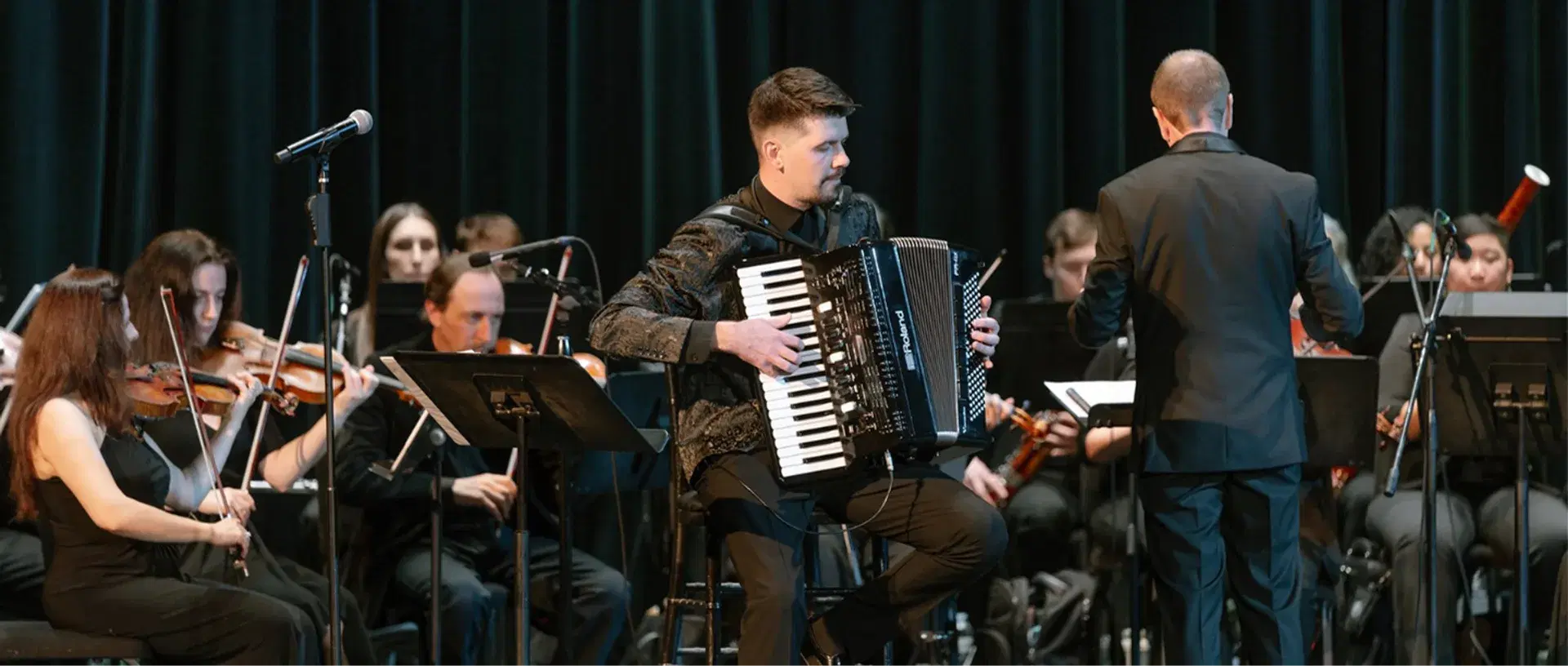 Aleksei Chebeliuk performing accordion with an orchestra
